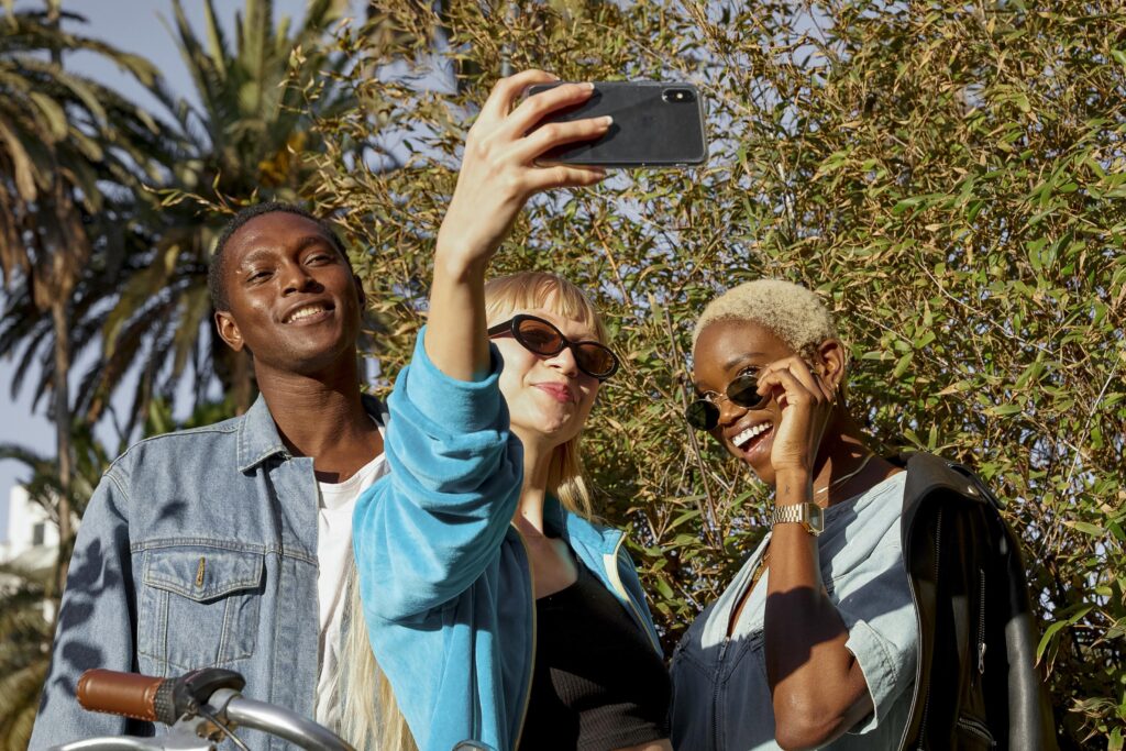medium shot happy people taking selfie